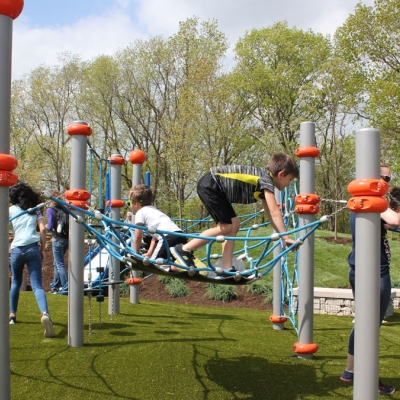 A boy climbs on netting at O'Day Park playground